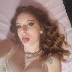 Pretty blond submissive worships balls with tied up tongue